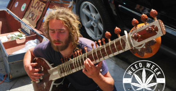 man with closed eyes, plays a guitar